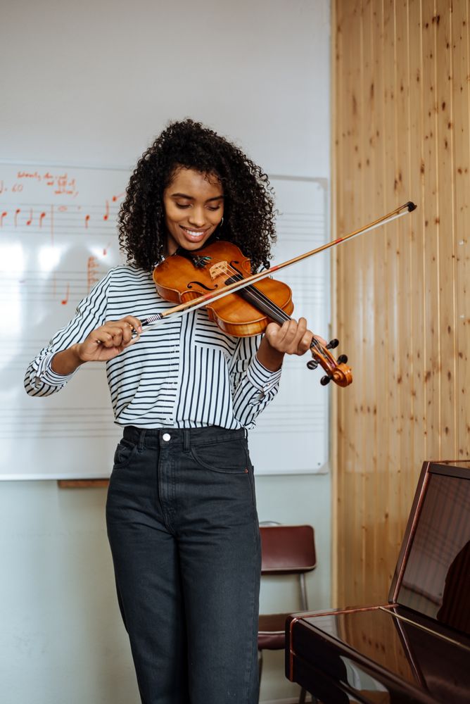 Woman playing violin in studio