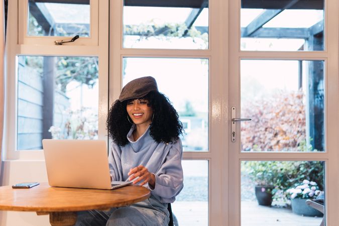 Smiling Black woman working on laptop