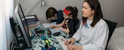 Woman teleworking with her children doing homework