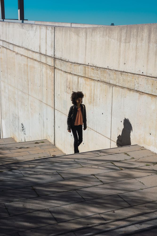 Black woman walking down the street.