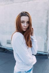 Portrait of red haired woman outside