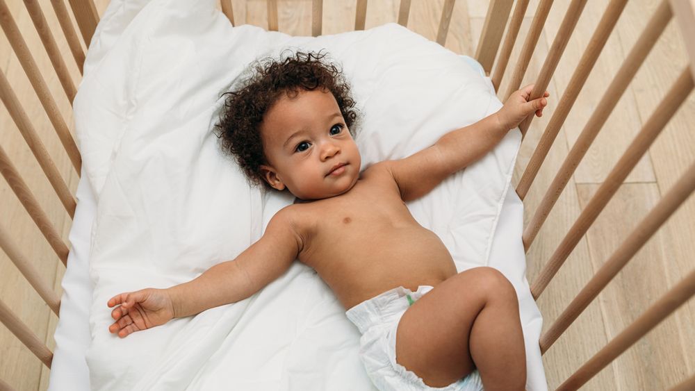 Cute toddler lying in his crib