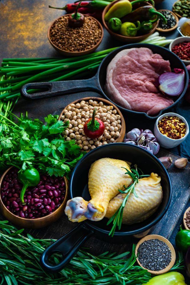 Grains and uncooked meats on kitchen counter in preparation for dinner