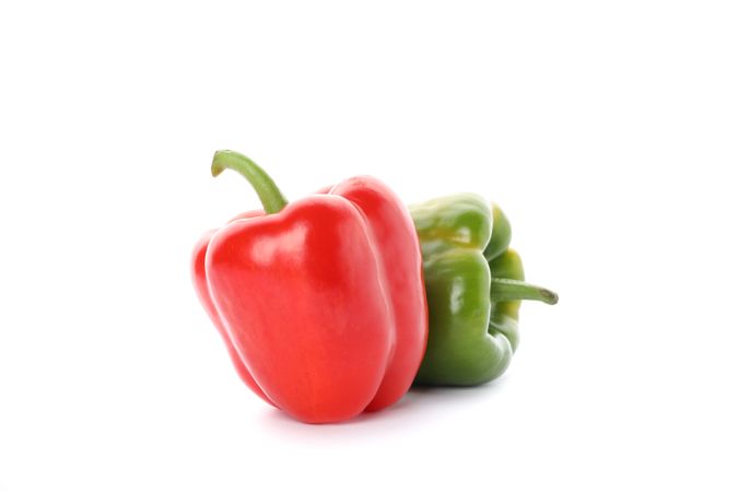 Green and red bell peppers isolated on plain background