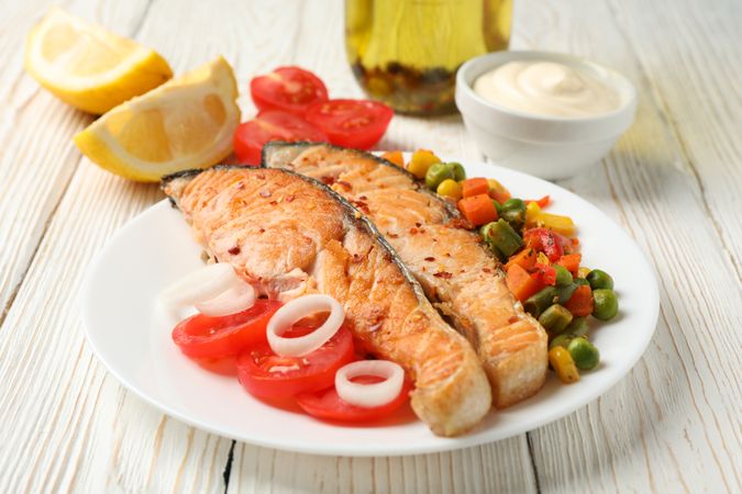 Composition with tasty grilled salmon on wooden background, close up
