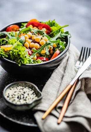 Organic vegetable salad with garbanzo beans and sesame seeds