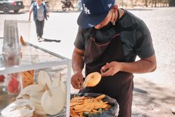 Man preparing mango at fruit stall