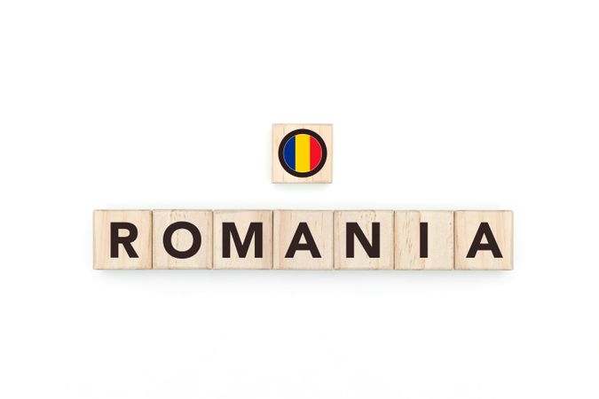 Wooden blocks bearing the name and flag of Romania. Romanian and East European Culture, national identity, travel, and geography in a copy space design.