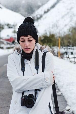 Woman walking in snowy mountains