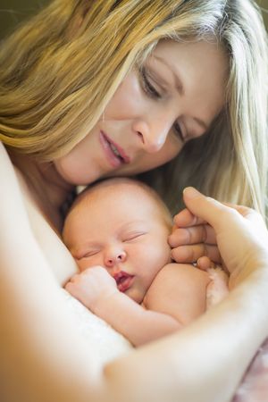 Calm Mother Holding Her Newborn Baby Girl