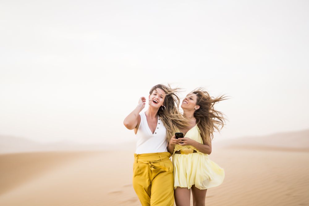 Happy women walking in the desert in desert
