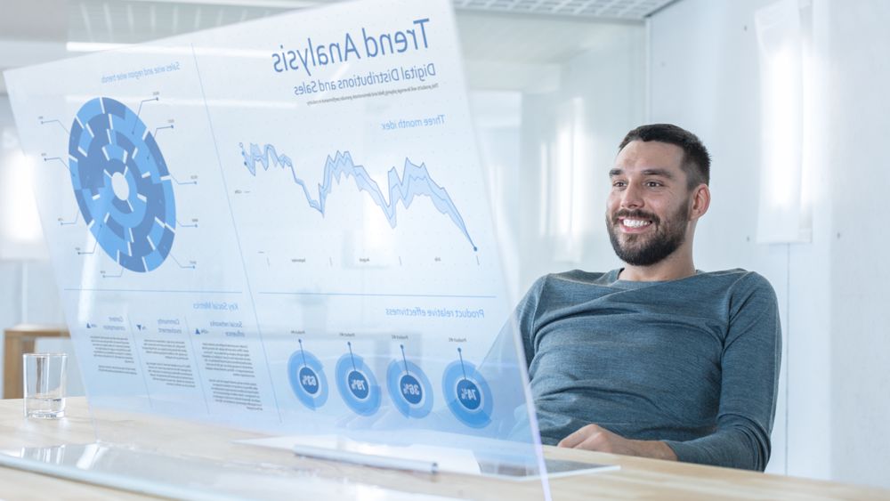 In the Near Future Successful Smiling Trader Works on Computer with Transparent Display