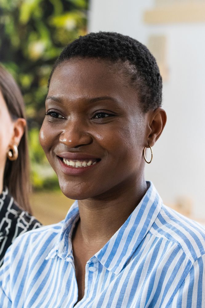 Delighted Black woman with short hair looking away