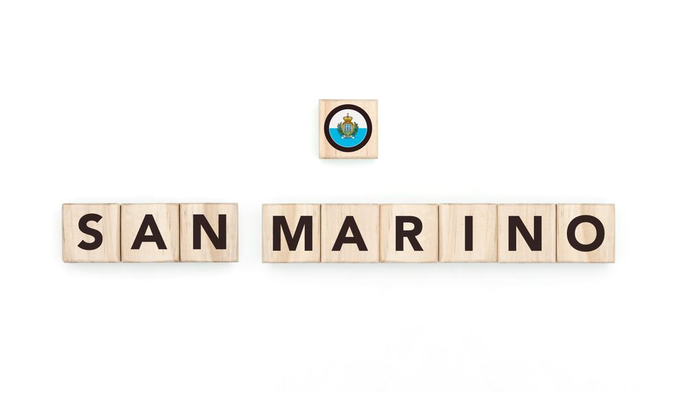 Wooden blocks bearing the name and flag of San Marino. Sammarinese and European and Mediterranean Culture, national identity, travel, and geography in a copy space design.