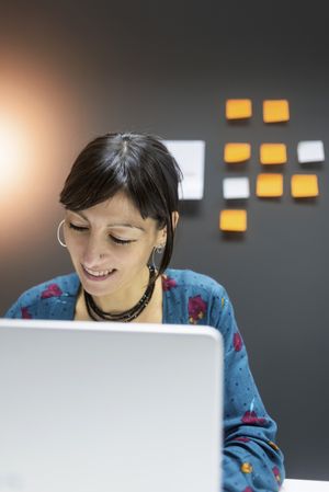 Smiling businesswoman working with laptop