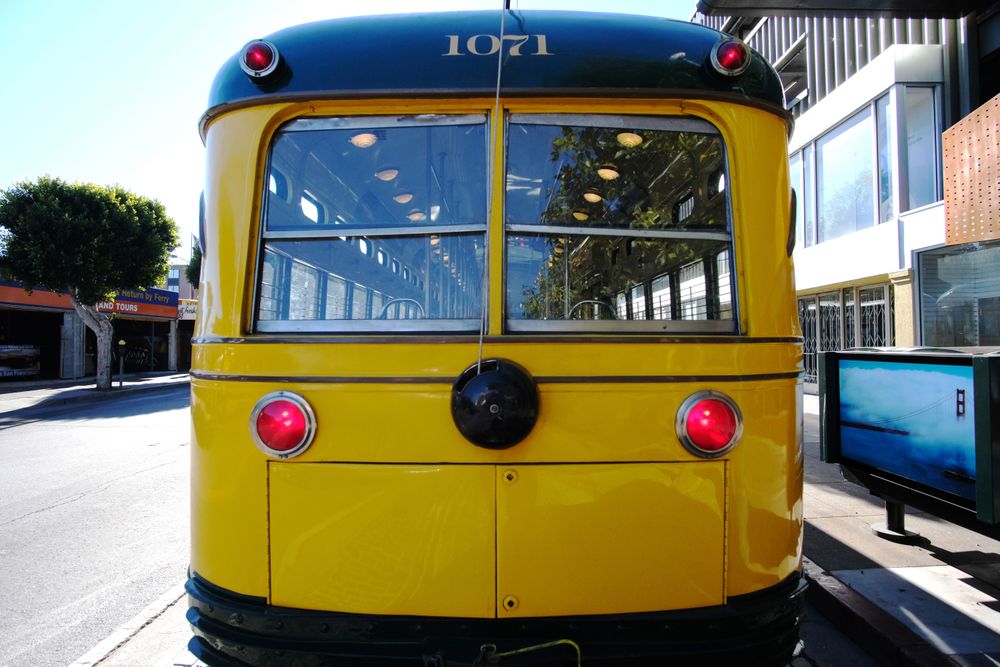 Yellow bus on modern city street