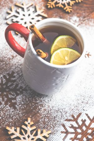 Warm Christmas drink with citrus slice and cinnamon stick