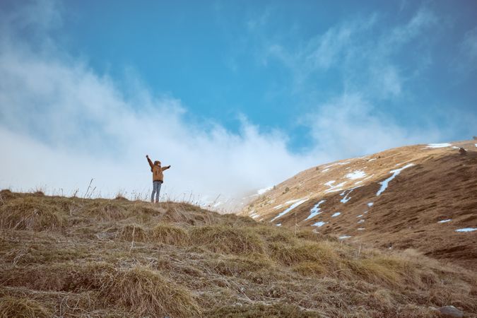 Anonymous boy on grassy hill