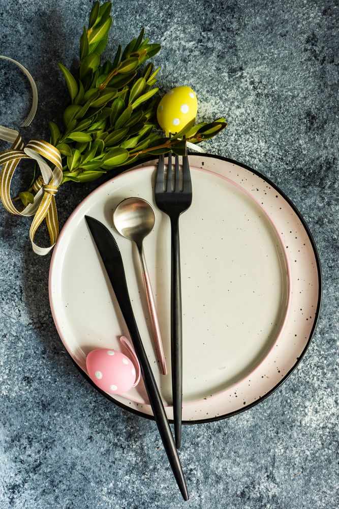Easter card concept with pastel egg decor and branch adorning plate