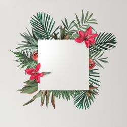 Leaves and red flowers on grey background with paper card