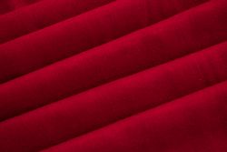 Close up Red folded Fabric Background Texture.