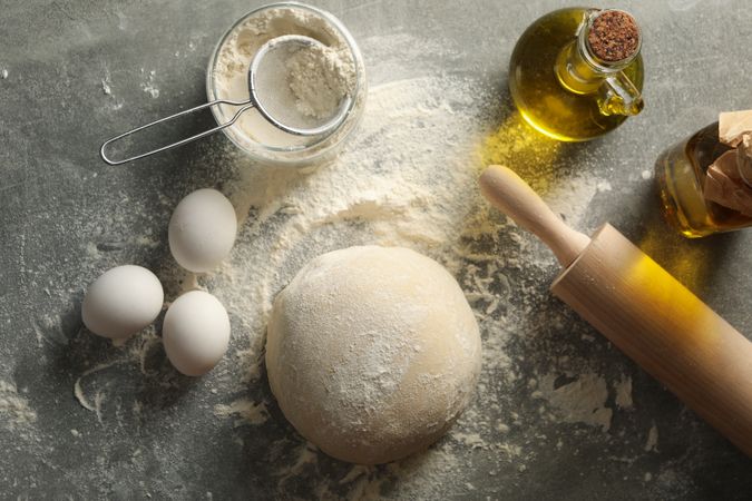 Concept for baking with dough on gray background