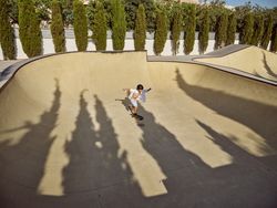 Boy riding longboard on sunny day