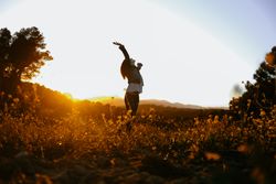 Woman walking on meadow and enjoying freedom