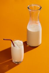 Horchata with ice cubes on yellow