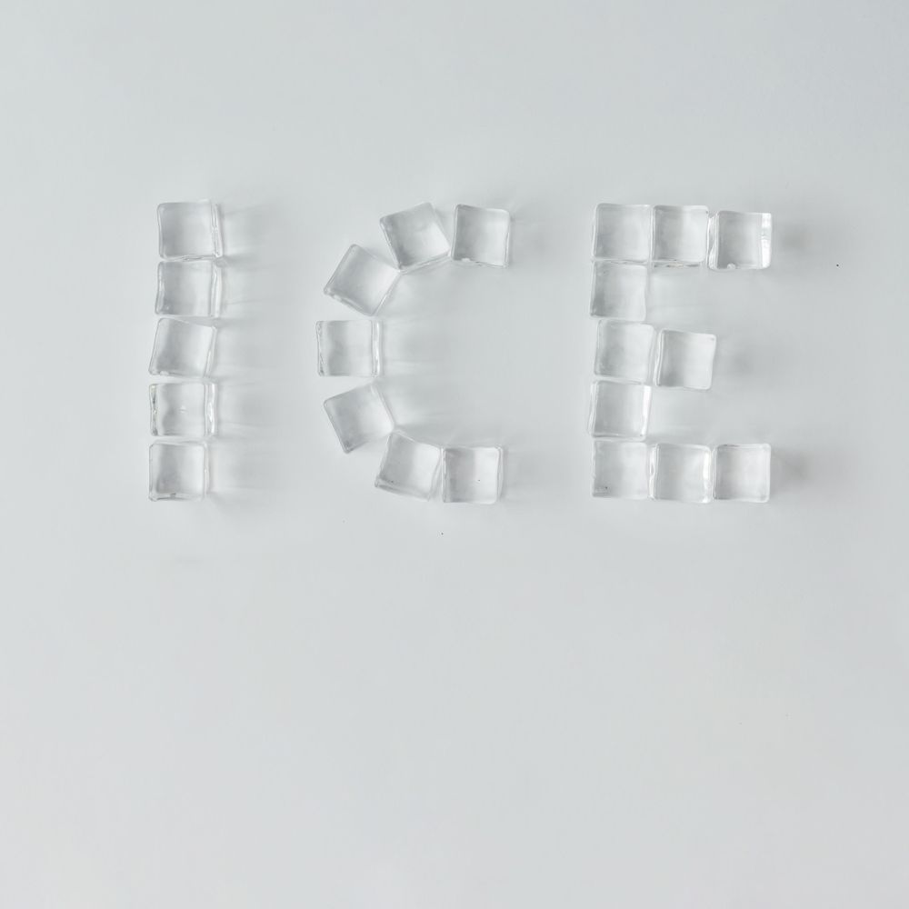 Ice cubes making “ICE” word on bright background
