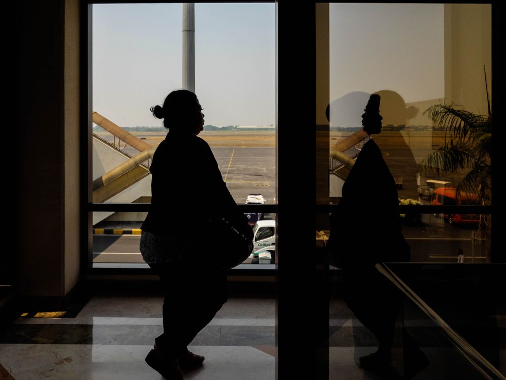 Silhouette of woman walking indoor