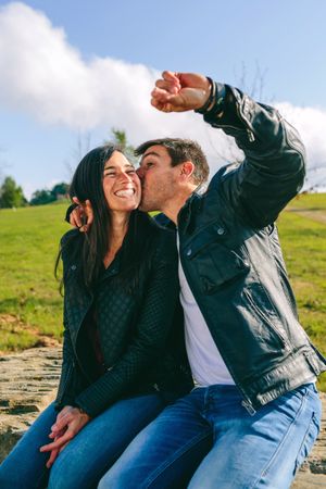 Couple kissing and taking a selfie with a smartwatch