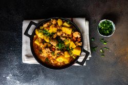 Top view of Georgian meat and vegetable stew Souzi served with herb, with space for text