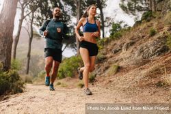 Fit couple running on mountain trail in morning 4AMvN4