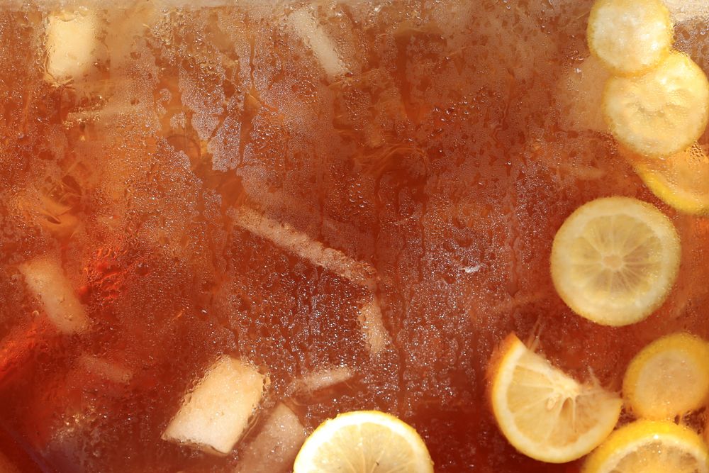 Textured Background of Lemon Tea in Glass Container