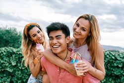 Happy man carrying his girlfriend on the back and having a good time