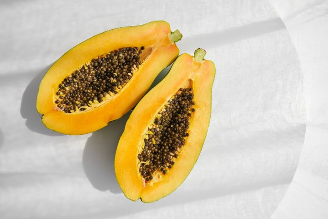 Ripe papaya fruit on gray background