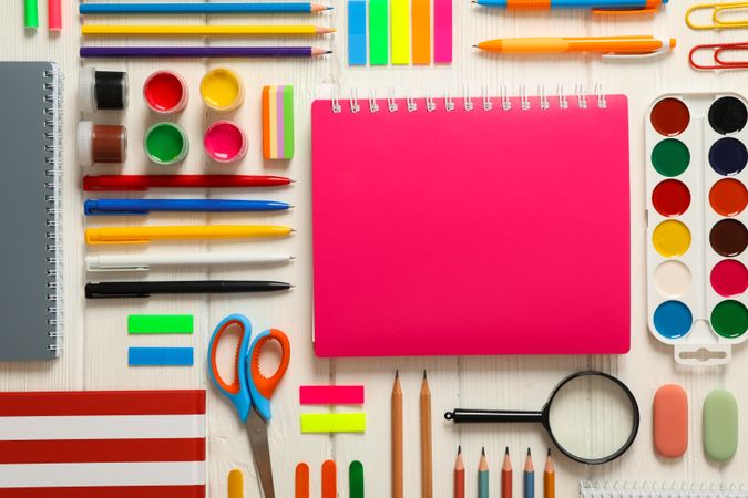 Flat lay composition with school supplies on wooden background