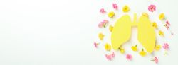 Banner of yellow lungs surrounded with flowers with copy space
