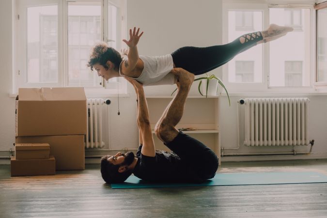 couple practicing yoga together at home