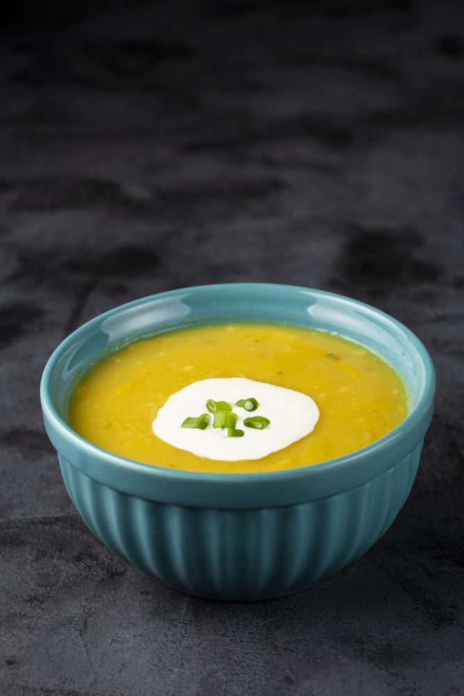 Bowl with pumpkin soup on the table.