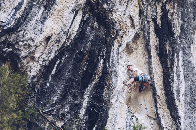 Anonymous man climbing rock