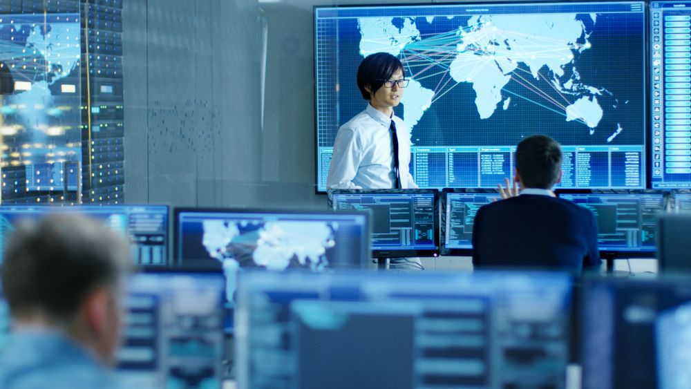 In the System Control Room Manager Holds a Briefing for His Staff Members.