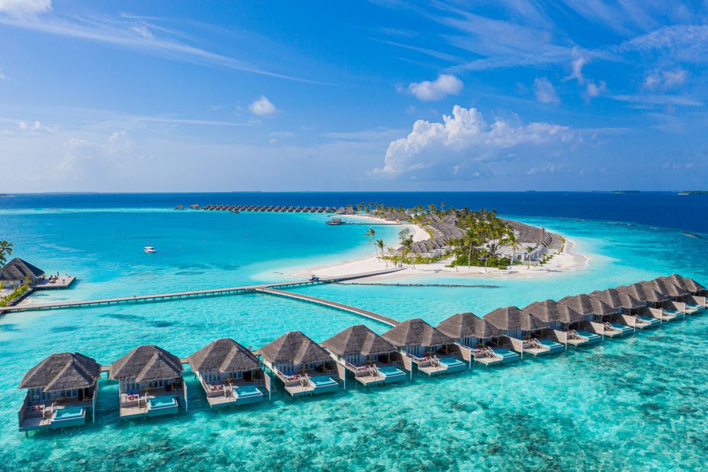 Villas lined up in the water of a tropical beach