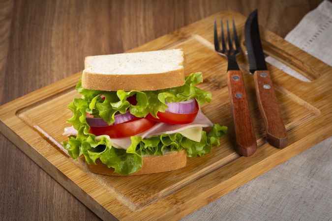 Natural sandwich. Sandwich with cheese, ham, lettuce, tomato and red onion.