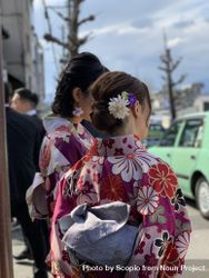 Two women in kimonos standing outdoor 5oox15
