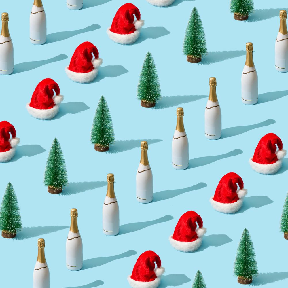 Christmas pattern made with Christmas tree and Santa Claus hat and champagne