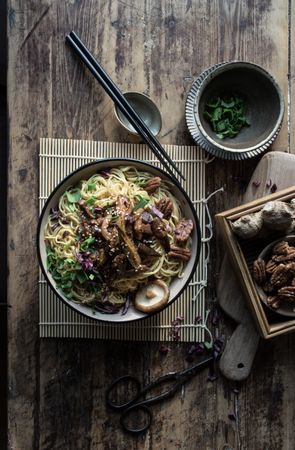 Miso noodles with egg plants and shiitake in bowl on table