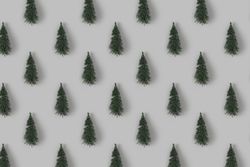 Holiday pattern with Christmas trees on gray background