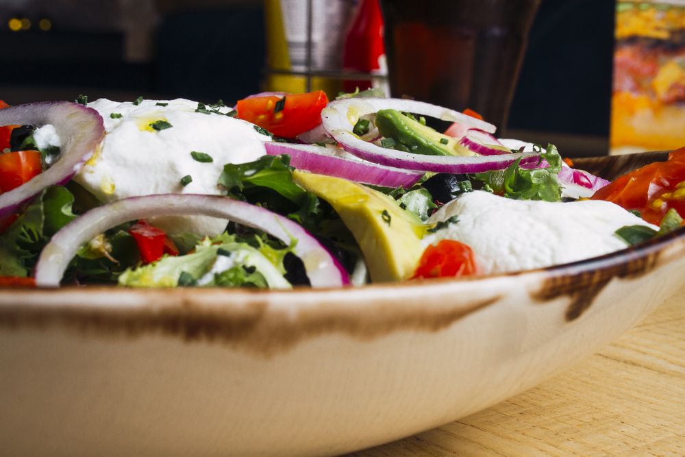 Vegetables salad with onion greens and cream sauce